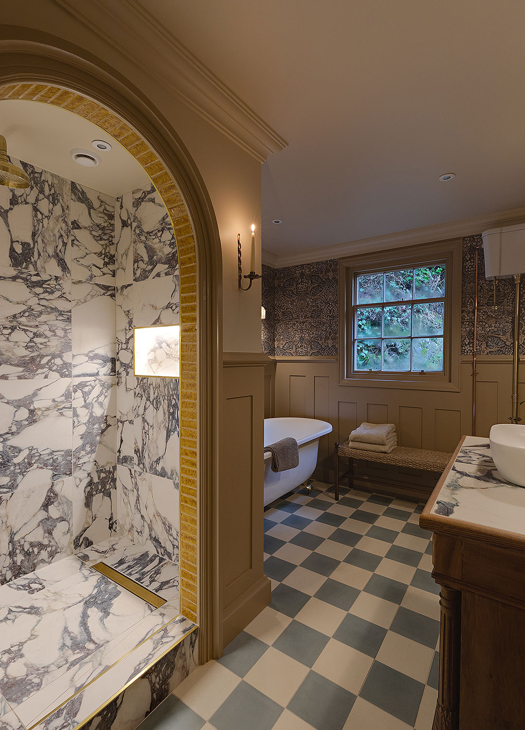 bathroom with walk-in arched shower and blue and white chequerboard tiled floor and rolltop bath