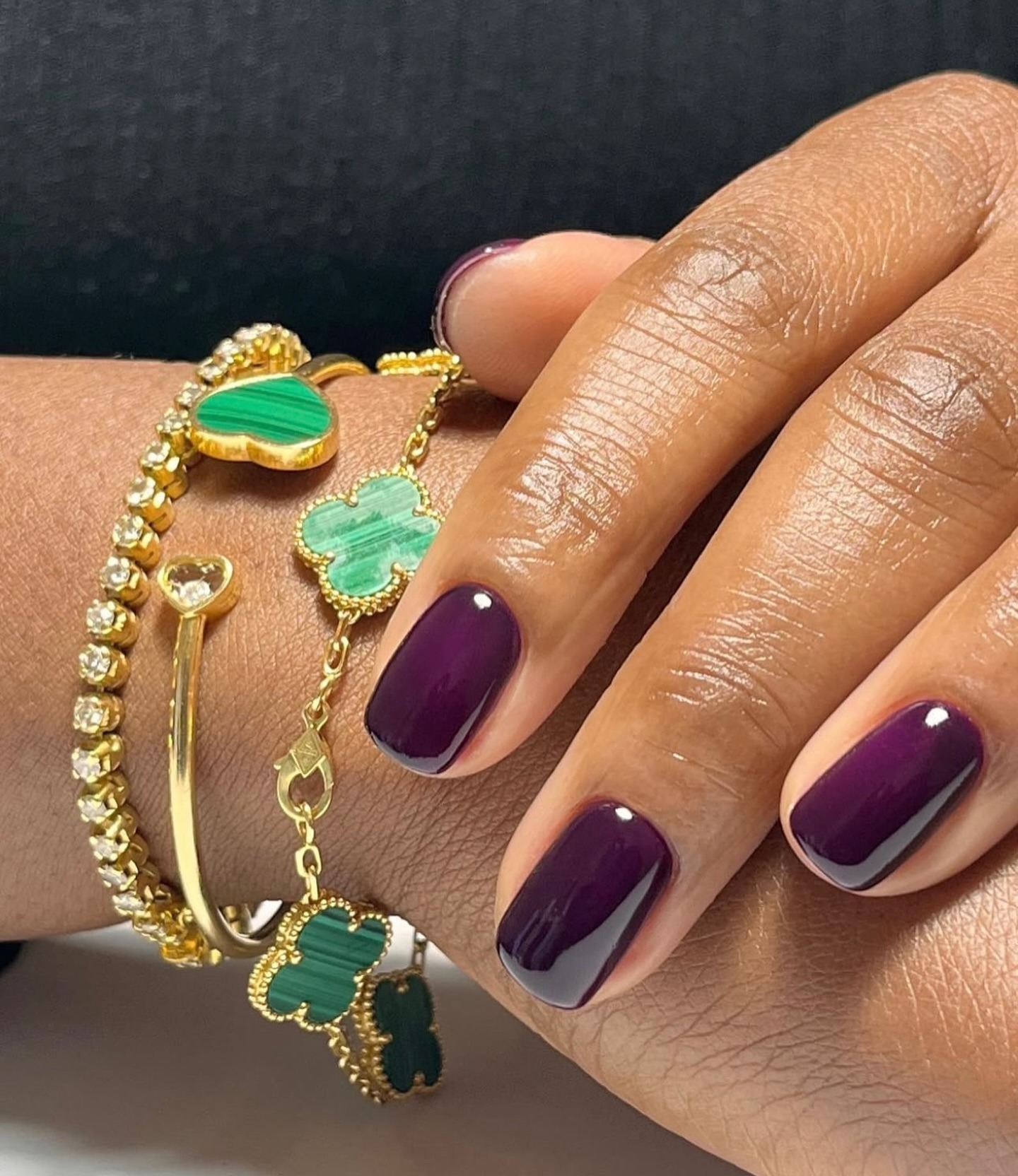 A close-up shot of a deep plum manicure