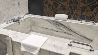 The deep marble bath tub in the suite