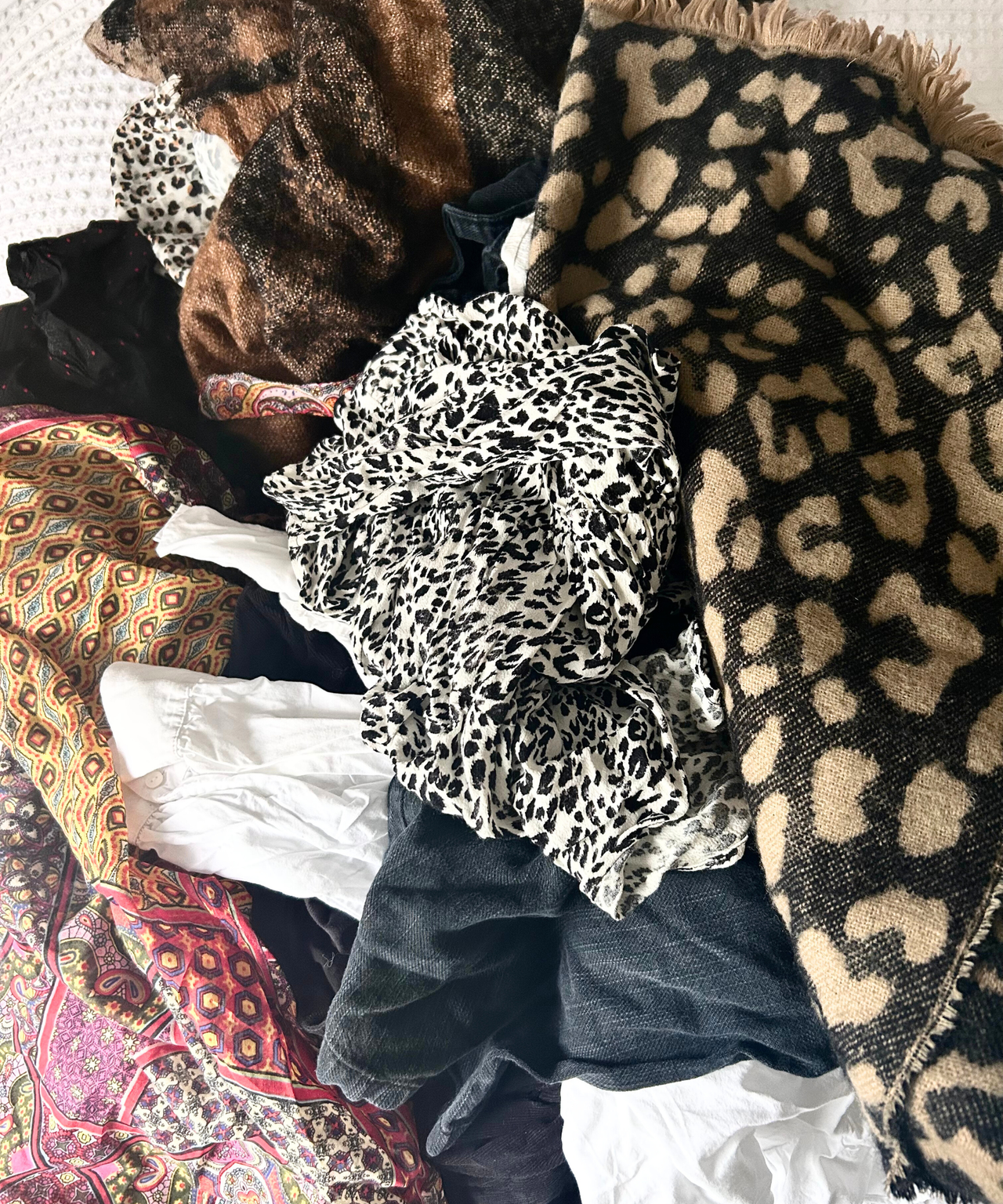 A pile of clothing on a bed