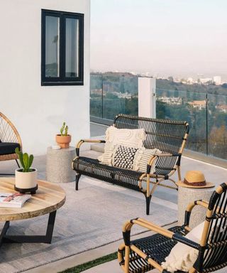 An outdoor area with garden furniture and assortment of outdoor cushions