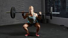 Woman performing the barbell back squat