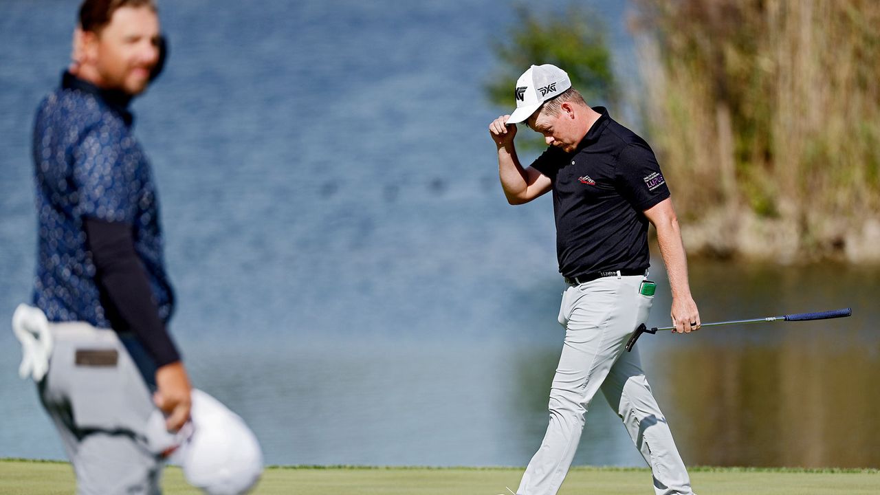 Shad Tuten walks off the green whilst adjusting his hat