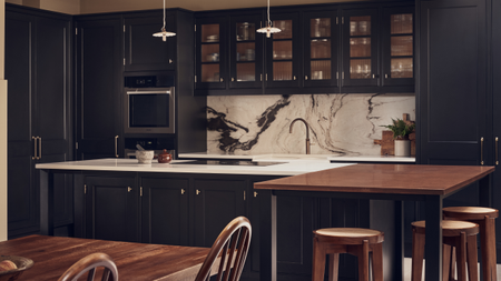 open plan modern kitchen with dark cabinetry, a split island, and a marble backsplash