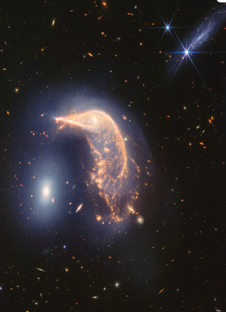 A dark background of space has a shining galaxy view in front of it, sort of shaped like a penguin. There's a glowing white orb toward the bottom right, representing the "egg" galaxy.