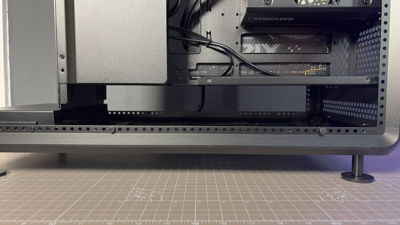 The CoolerMaster MasterFrame 360 Panoramic PC case with various components installed on a desk.