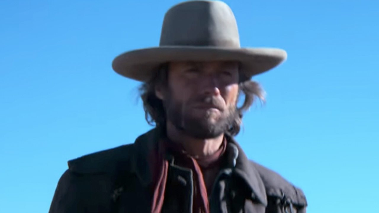 Clint Eastwood as Josey Wales, wearing a white hat in front of a bright blue sky 