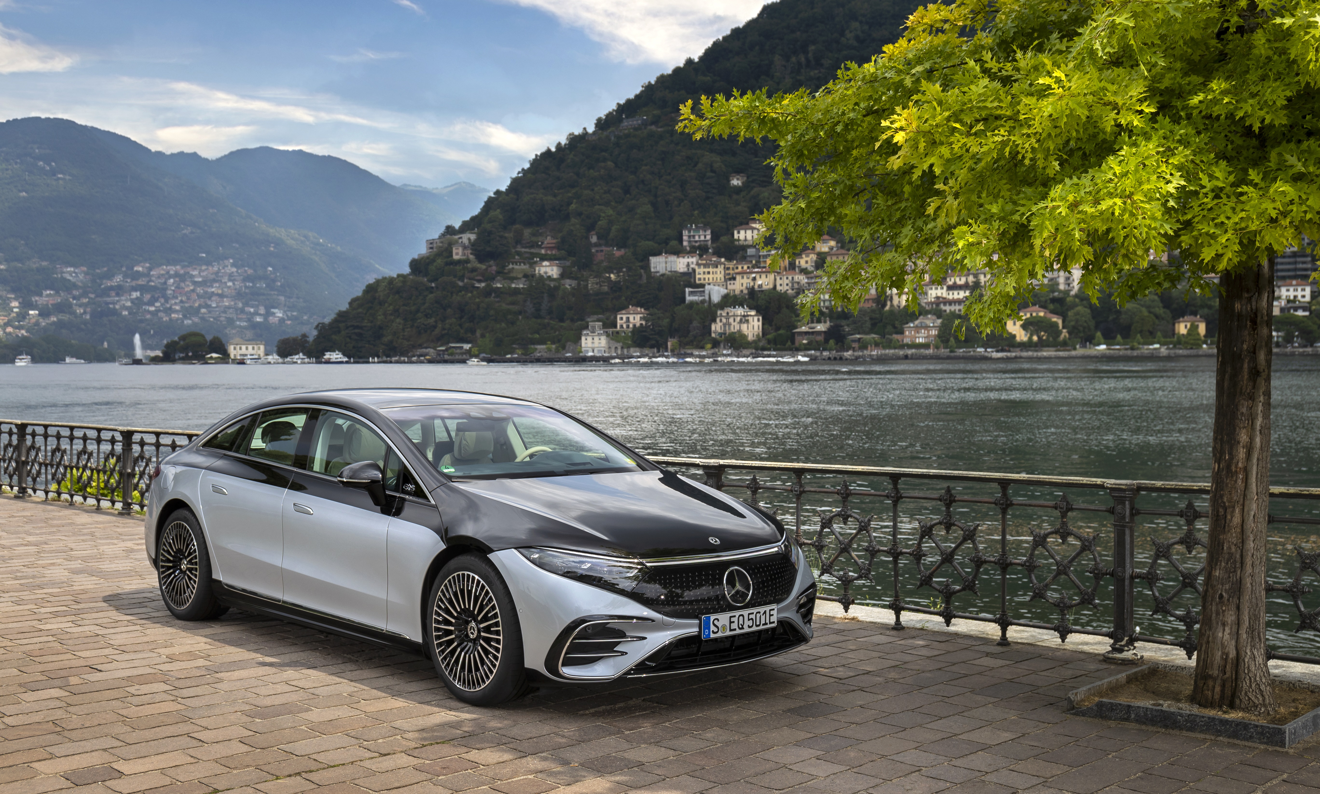 mercedes eqs parked next to a lake