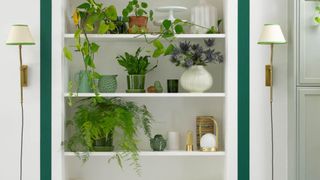 Green paint mixed with metallic accessories such as lights and vases to illustrate the forest green color trend