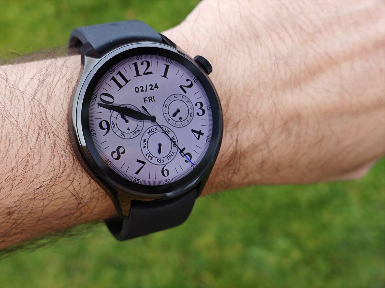The Xiaomi Watch S1 Pro worn with a green background
