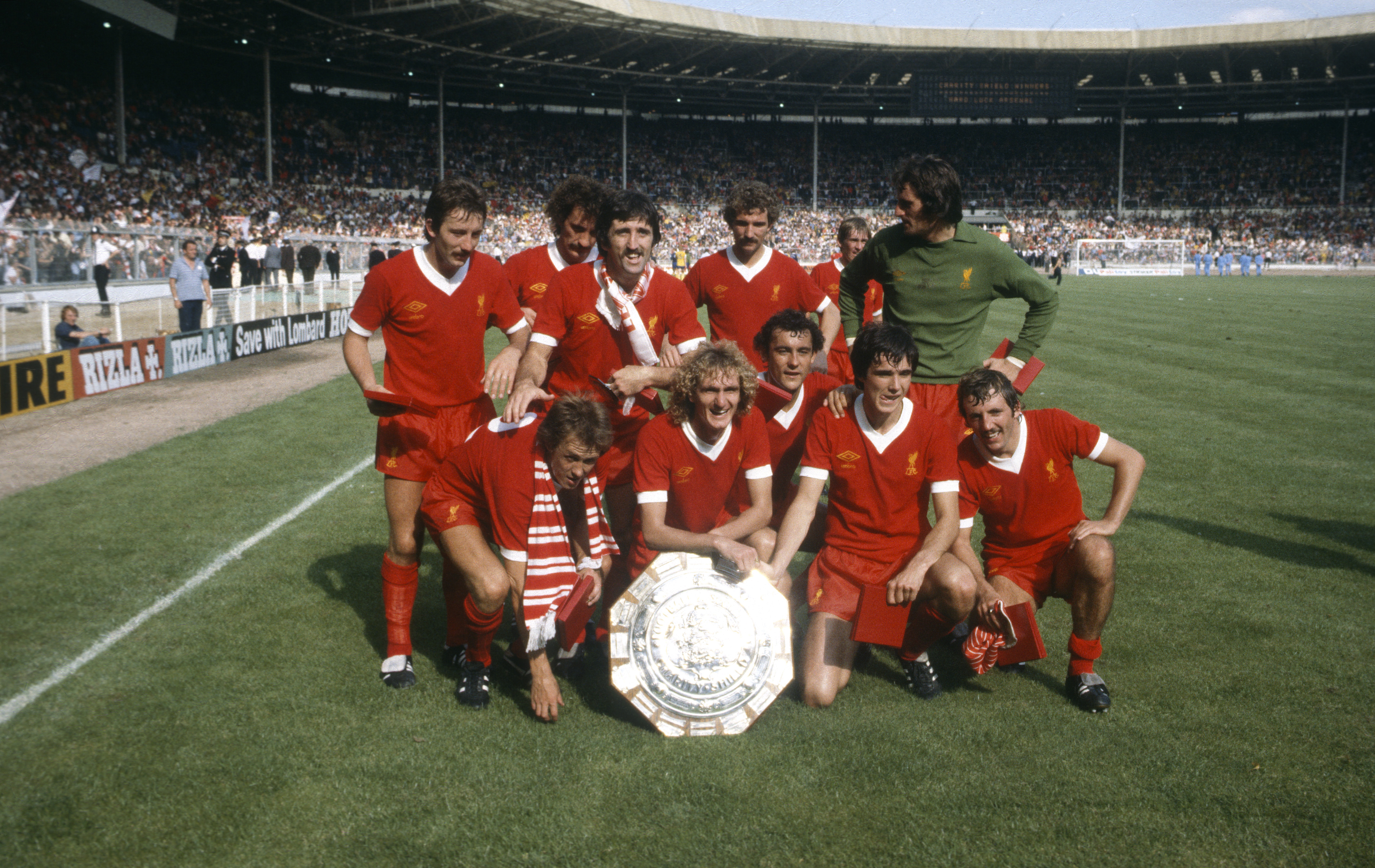 Liverpool players pose with the Charity Shield after beating Arsenal at Wembley in August 1979.