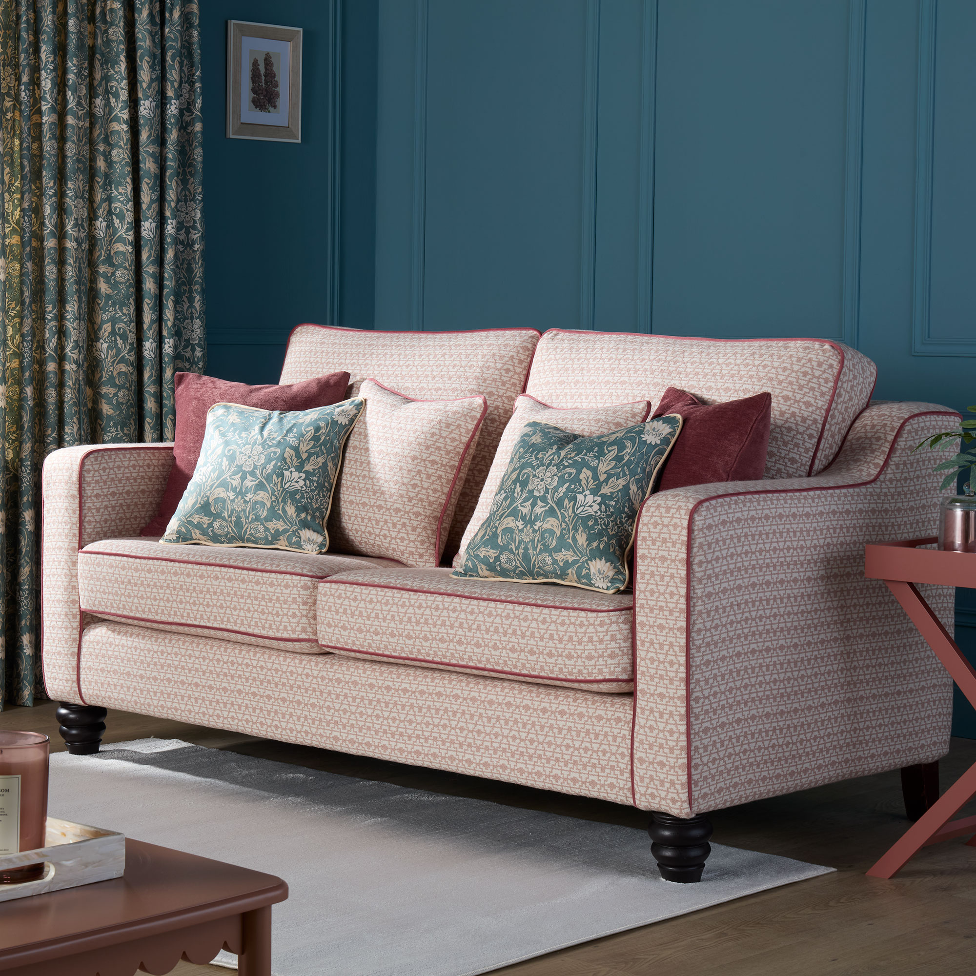 Pink patterned sofa with red piping