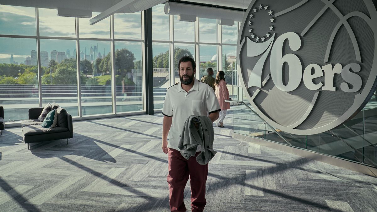 Adam Sandler walks through the &#039;76ers lobby in Hustle.