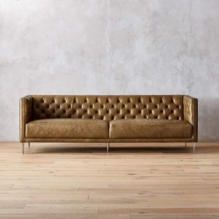 brown tufted leather sofa with angular frame