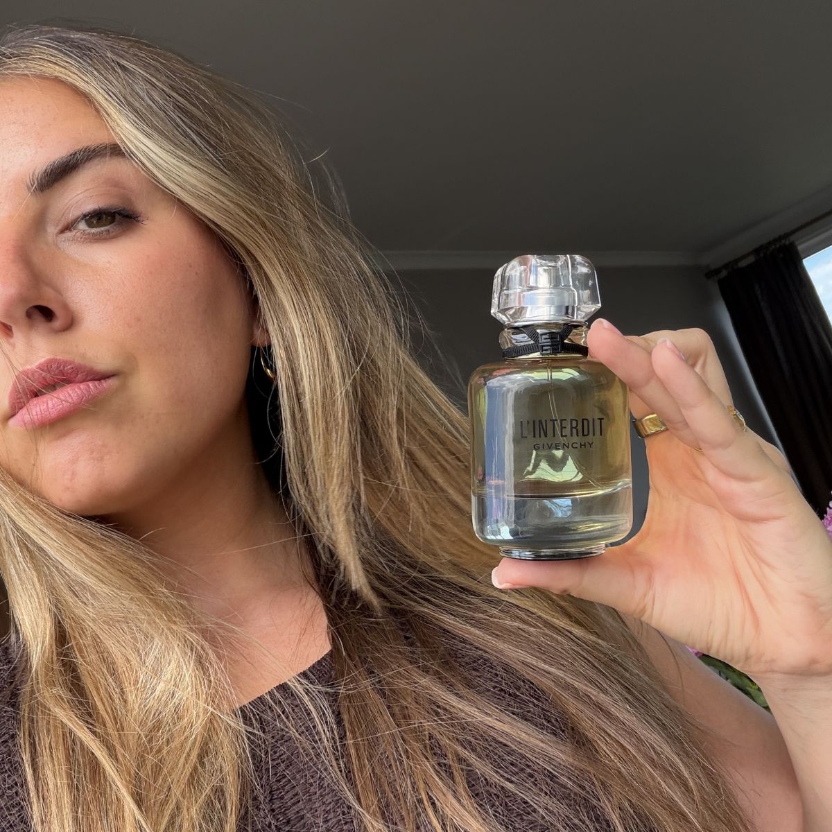 Shannon Lawlor holding Givenchy L'Interdit
