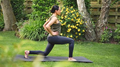 Woman doing glute workout on yoga mat in garden