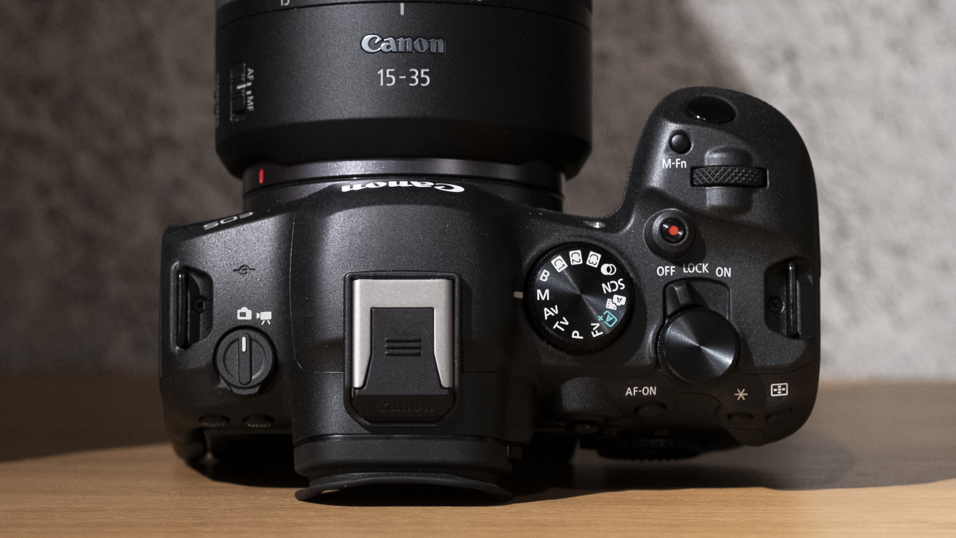 The Canon EOS R6 Mark II camera on a wooden shelf