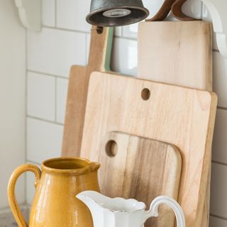 A stack of wooden cutting board on a kitchen worktop