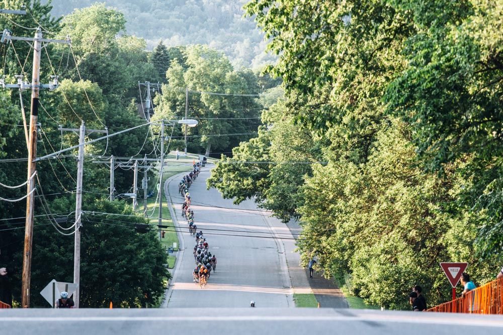 The chase speeds down the final downhill of the course, just before the climb to the finish.