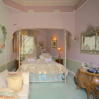bedroom with pink wall and mirror with table