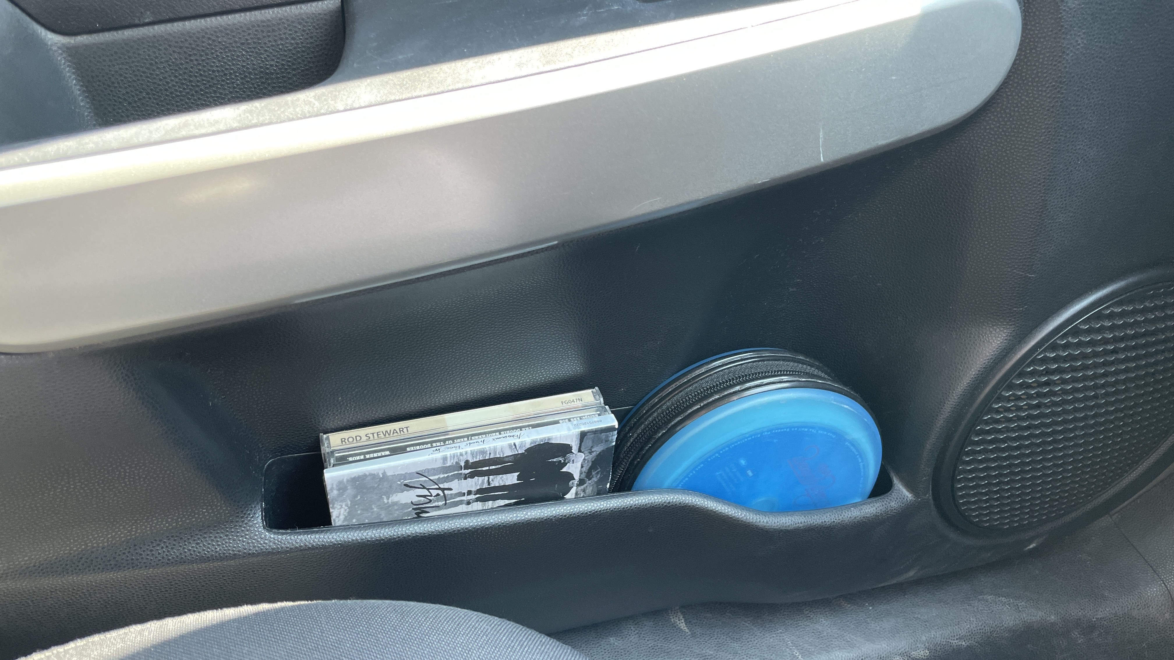 A car's CD player and burned CDs, on a hot day