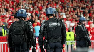 French riot police stood in front of Liverpool fans during the Champions League final against Real Madrid at the Stade de France.