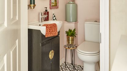 Pink downstairs bathroom with wallpaper