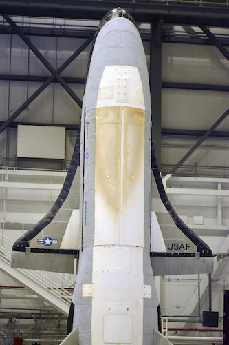 A space plane stands up on its end.