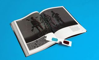 The open magazine featuring an image of a 4-person band behind a broken piece of glass