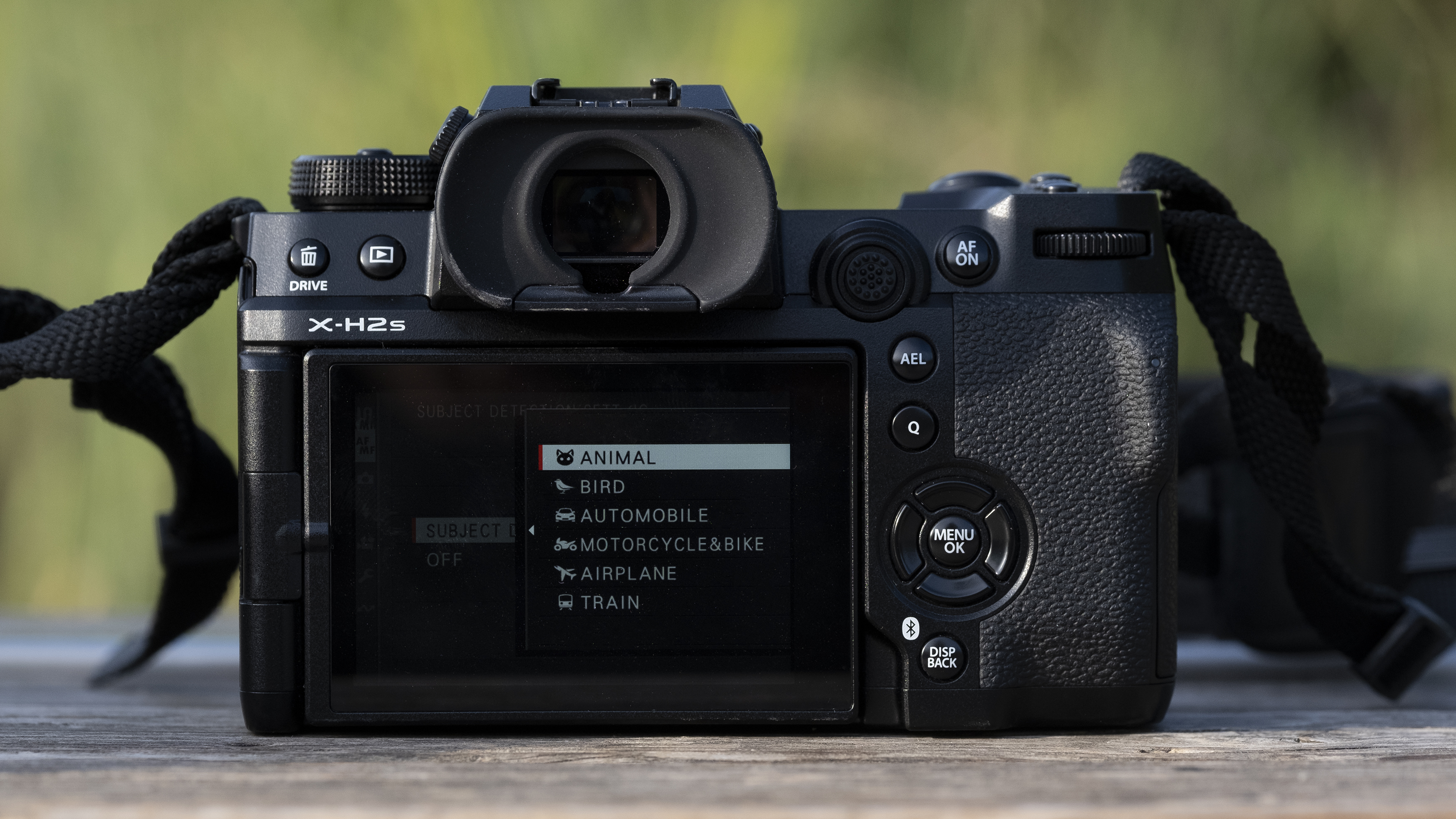 The Fujifilm X-H2S camera sitting on a wooden bench