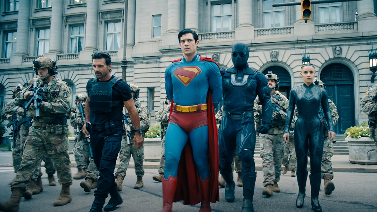 Superman is shown being taken into custody by soldiers and several other heroes in Superman (2025).