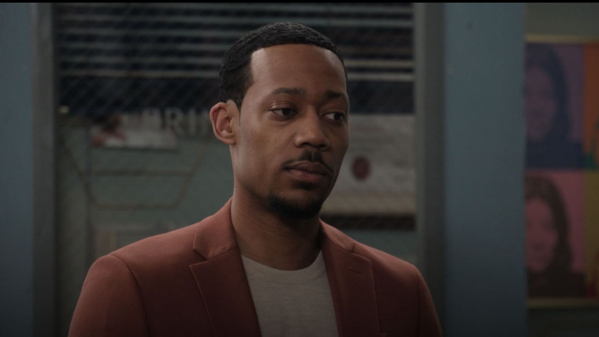 Tyler James William looking annoyed in a brown jacket as Gregory in Abbott Elementary Season 6