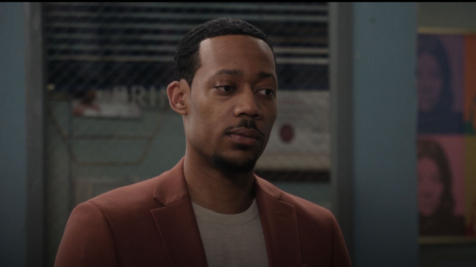 Tyler James William looking annoyed in a brown jacket as Gregory in Abbott Elementary Season 6