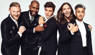 Queer Eye the Fab 5 dressed well and smiling