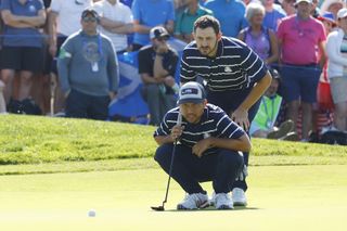 Players studying line of putt