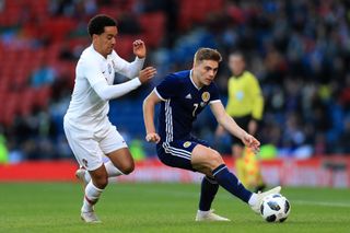 Portugal's Helder Costa competes for the ball with Scotland's James Forrest in a match in 2018.