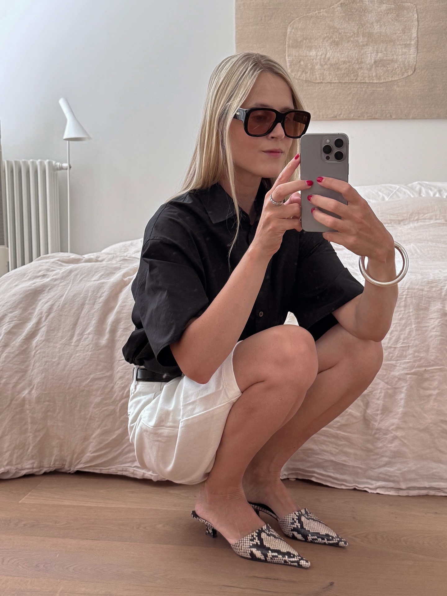 Influencer wearing snakeskin kitten heel mules