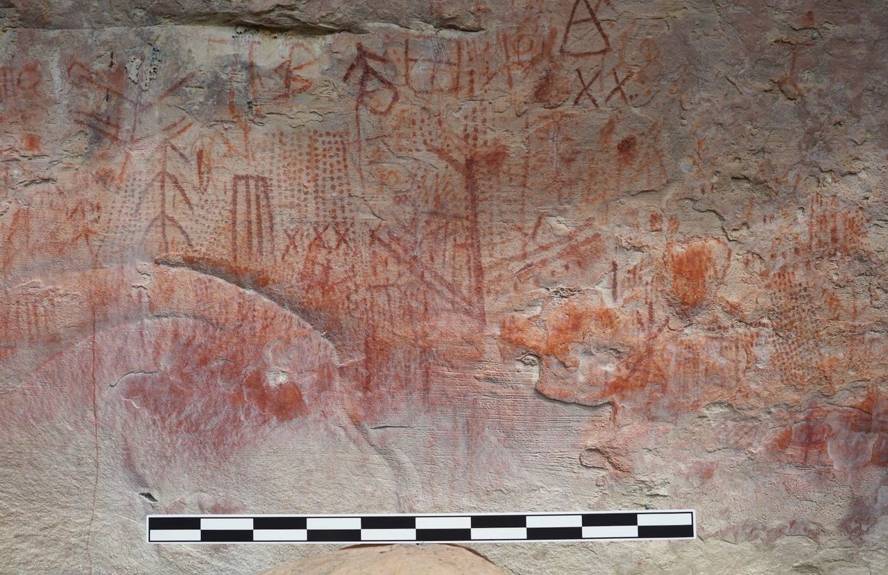 Rock art paintings of dots, geometric line forms, and symbols