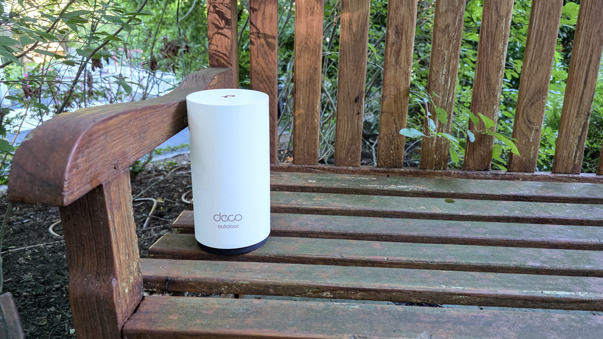 TP-Link Deco BE65-Outdoor on a garden bench