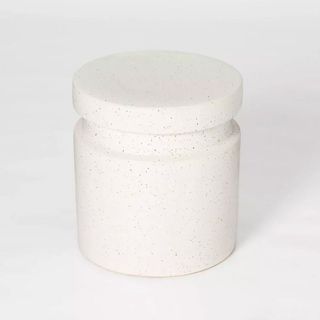 A white cylinder-shaped end table with speckled designs, for the best Target furniture pieces.