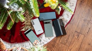The Samsung Galaxy Z Fold 4 and Galaxy S22, Google Pixel 6a and Pixel 7 Pro, and Moto G Power under a Christmas tree