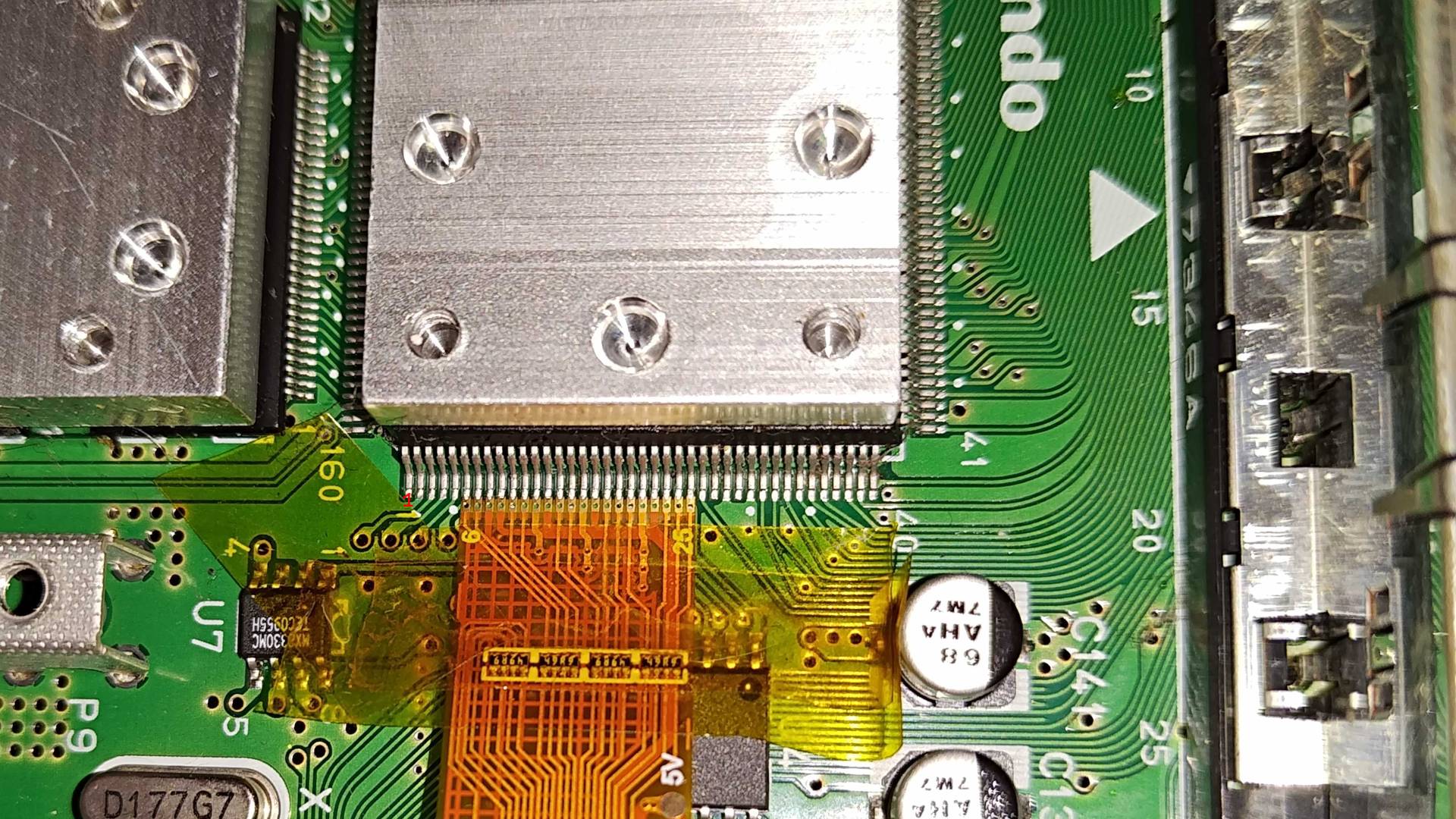N64 PPU with ribbon cable lined up at pins secured by kapton tape to board.