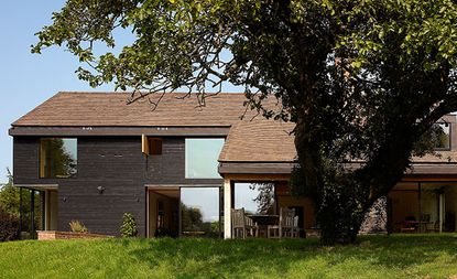Large cottage with wooden cladding on walls