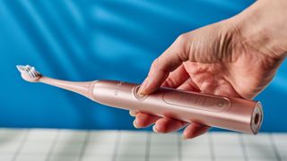The Ordo Sonic+ toothbrush photographed in front of a blue background.