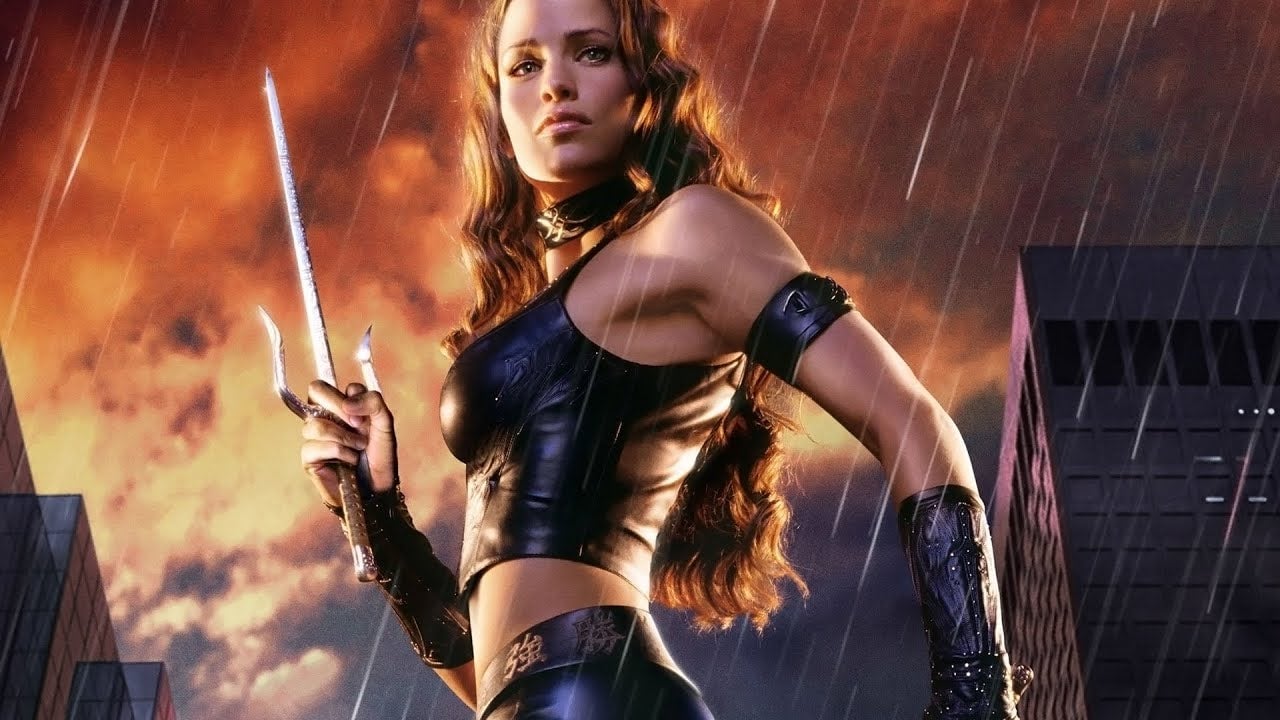 A promotional image for 2005's Elektra movie, showing the titular character with her sai weaponry