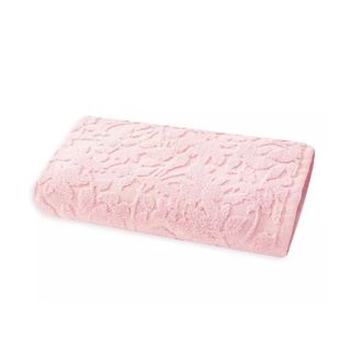 A folded rectangular light pink towel with a floral motif