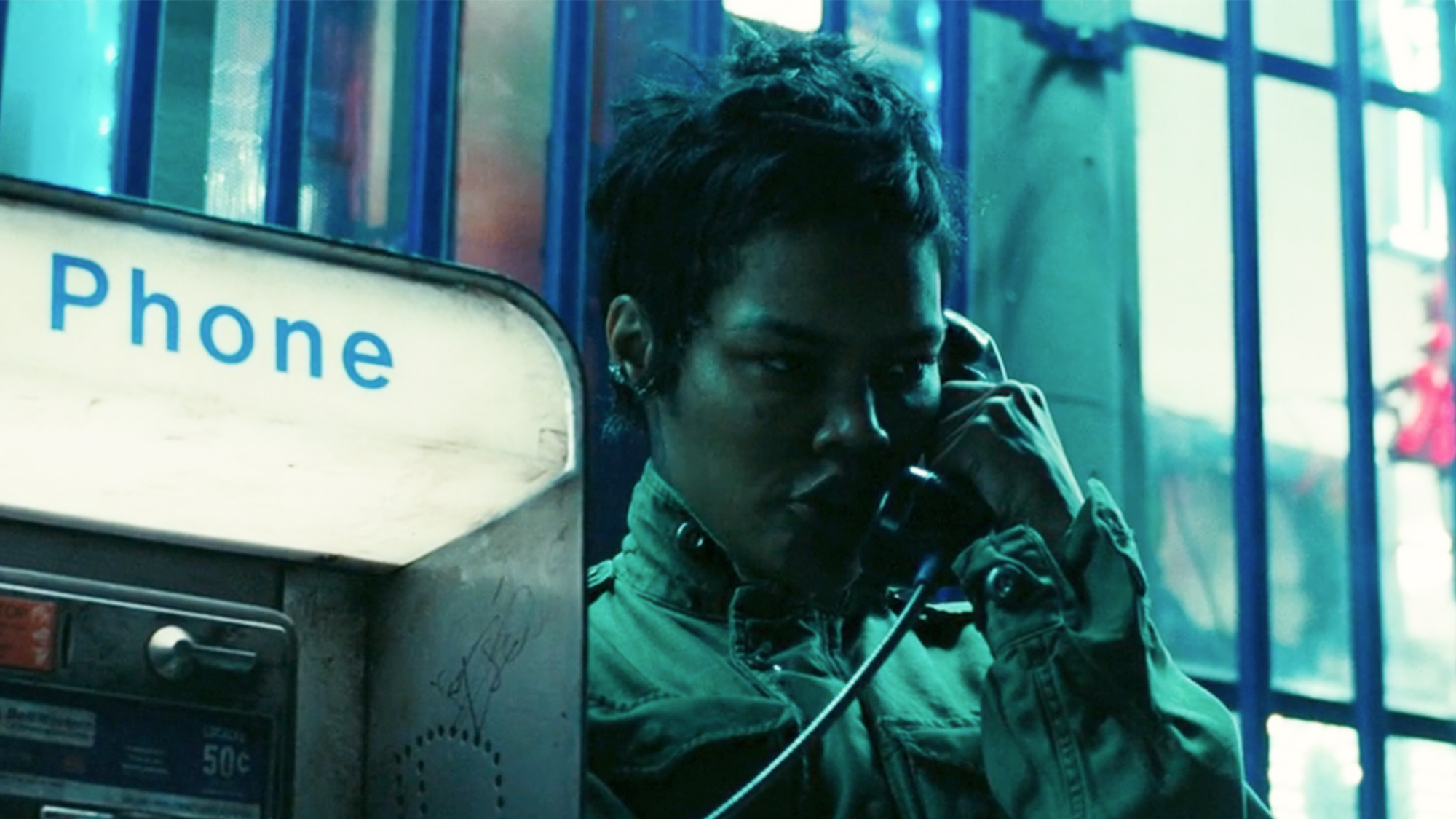 Teyana Taylor talking on a pay phone in One Battle After Another