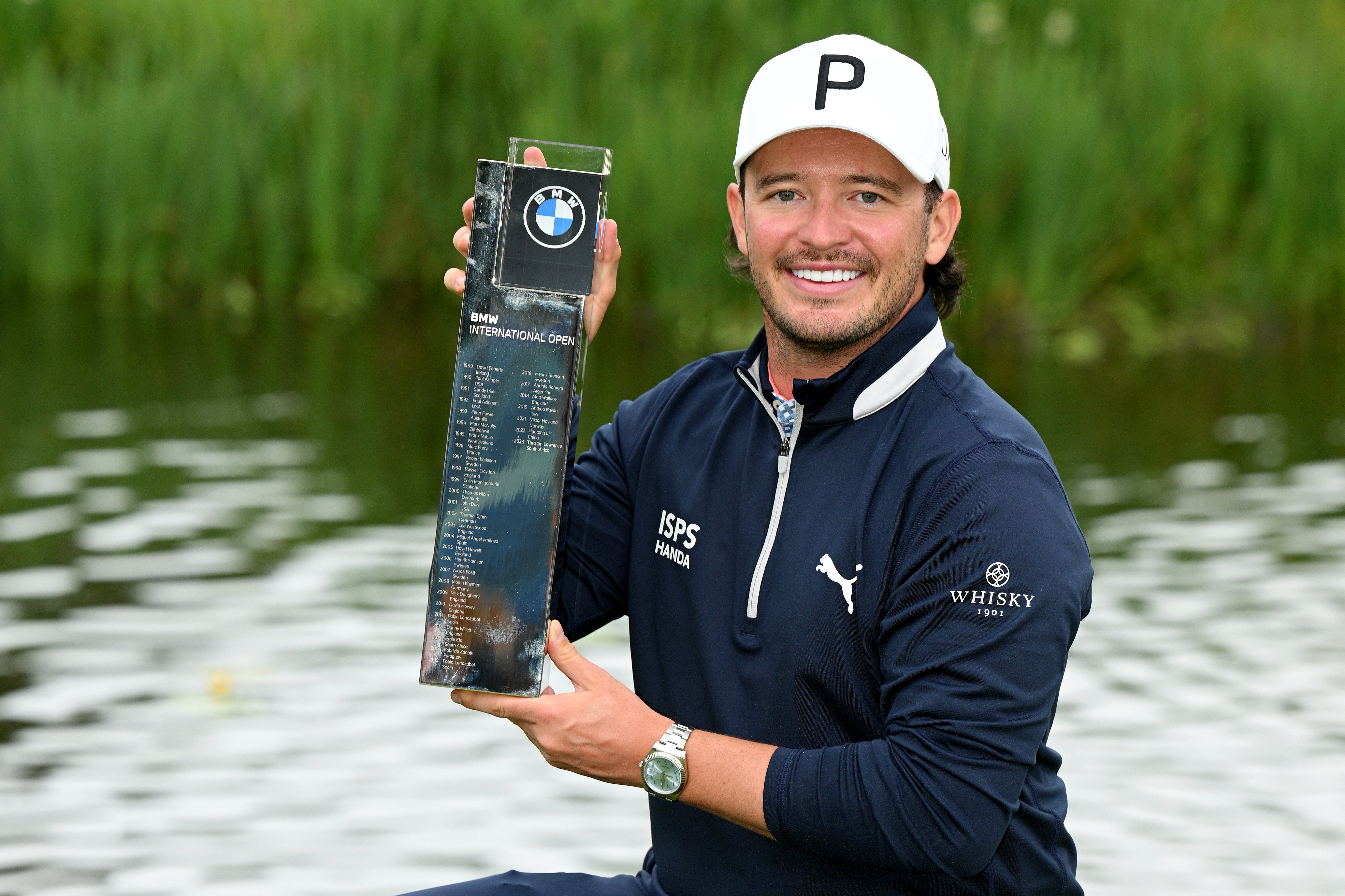 Ewen Ferguson poses with the BMW International Open trophy after winning in 2024