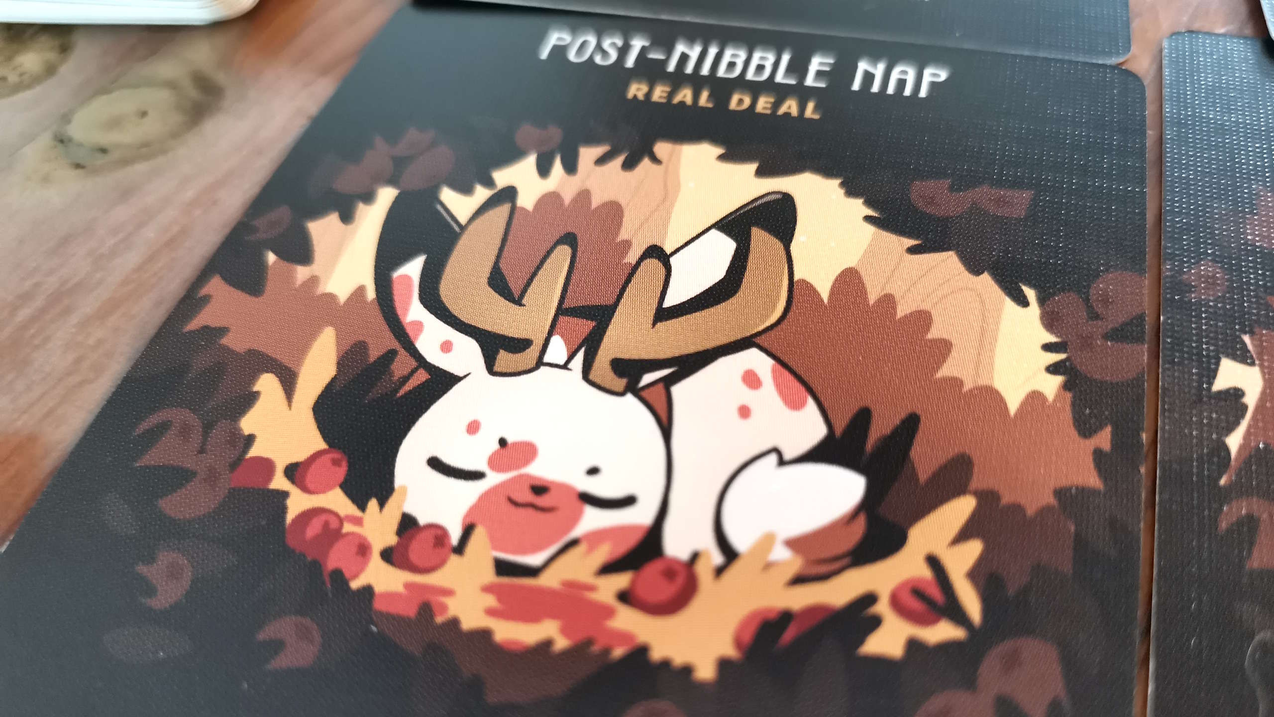 Twisted Cryptids card on a wooden surface