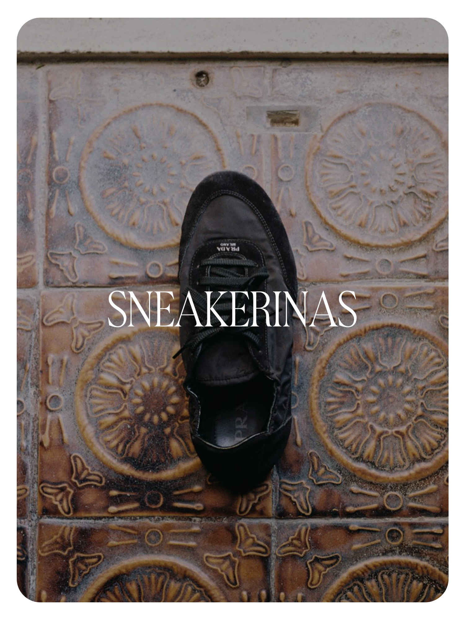 A close-up flat image of a black Prada ballerina-style sneaker. Text reads, &quot;Sneakerinas.&quot;